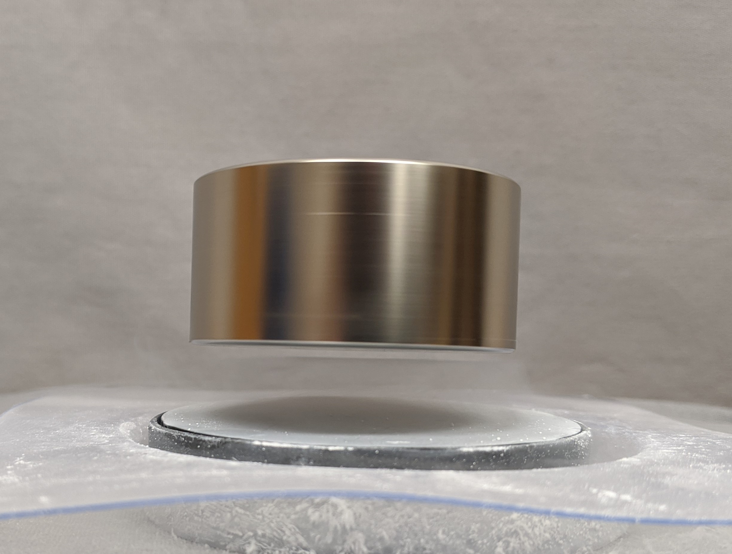 2" NIB suspended above large semicondutor puck.