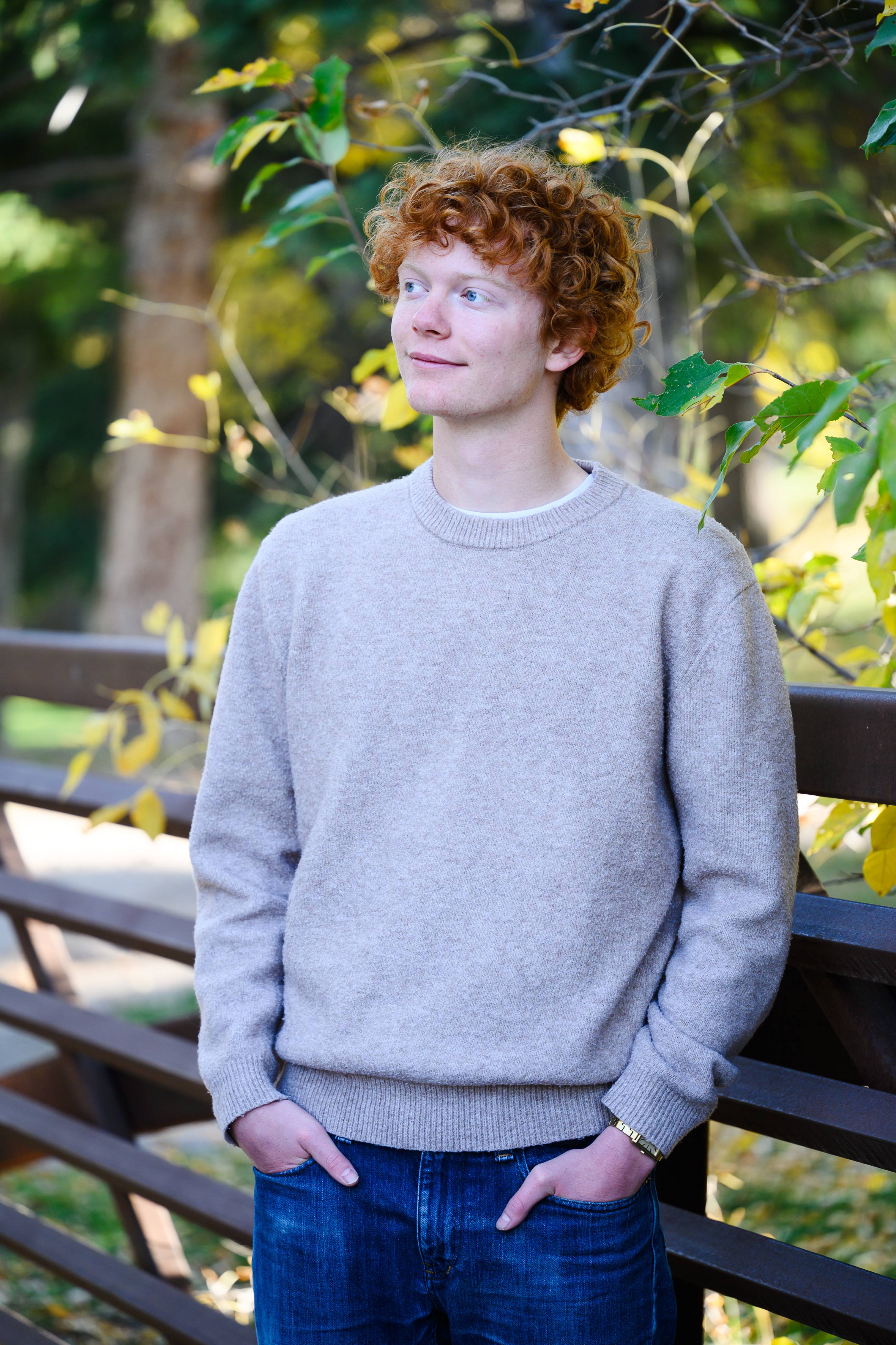 Ben standing next to a tree and being the only normal person on the officer team
